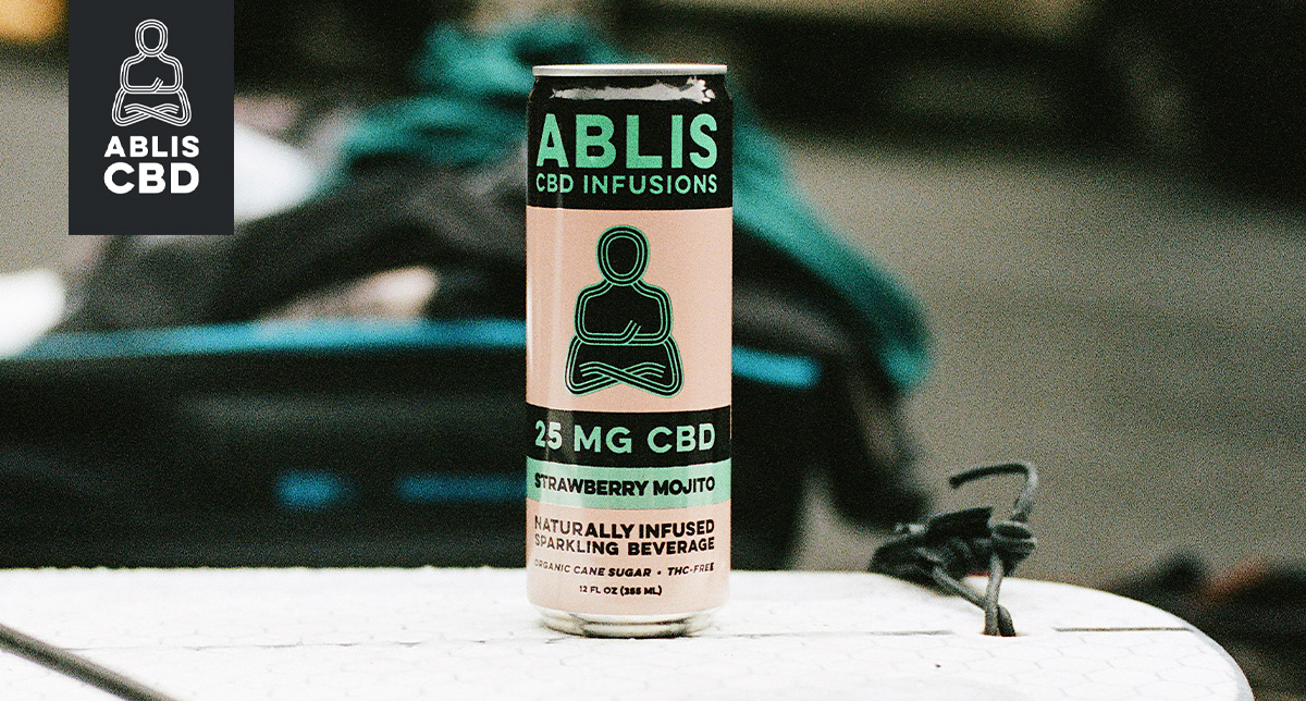 Close up of one of Ablis's CBD-infused drinks, Strawberry Mojito; it is in a pink can with the Ablis Buddha logo on the front